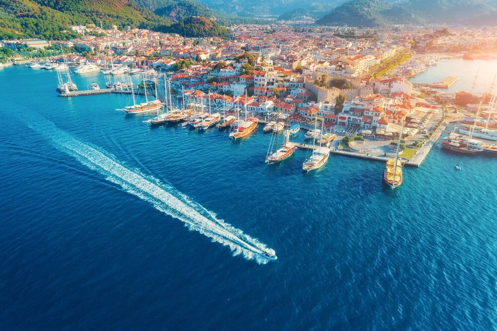 Aerial view of boats, yahts, floating ship and beautiful architecture at sunset in Marmaris, Turkey.